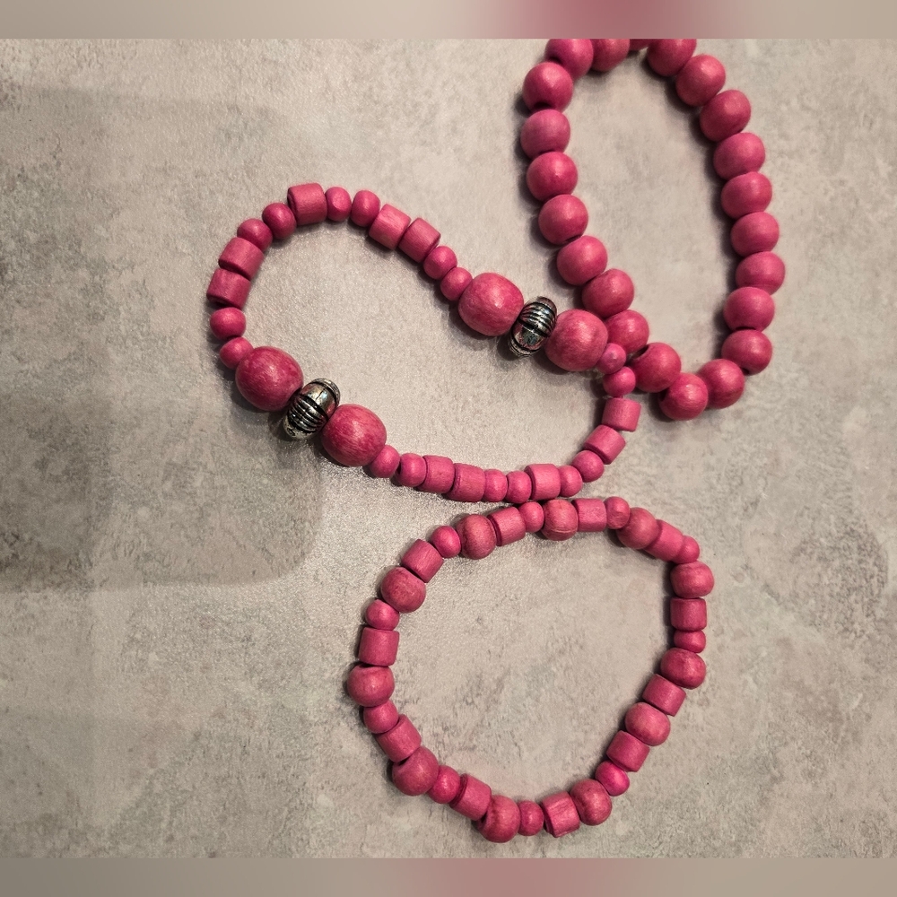 3 cute bright pink wooden beaded bracelets.